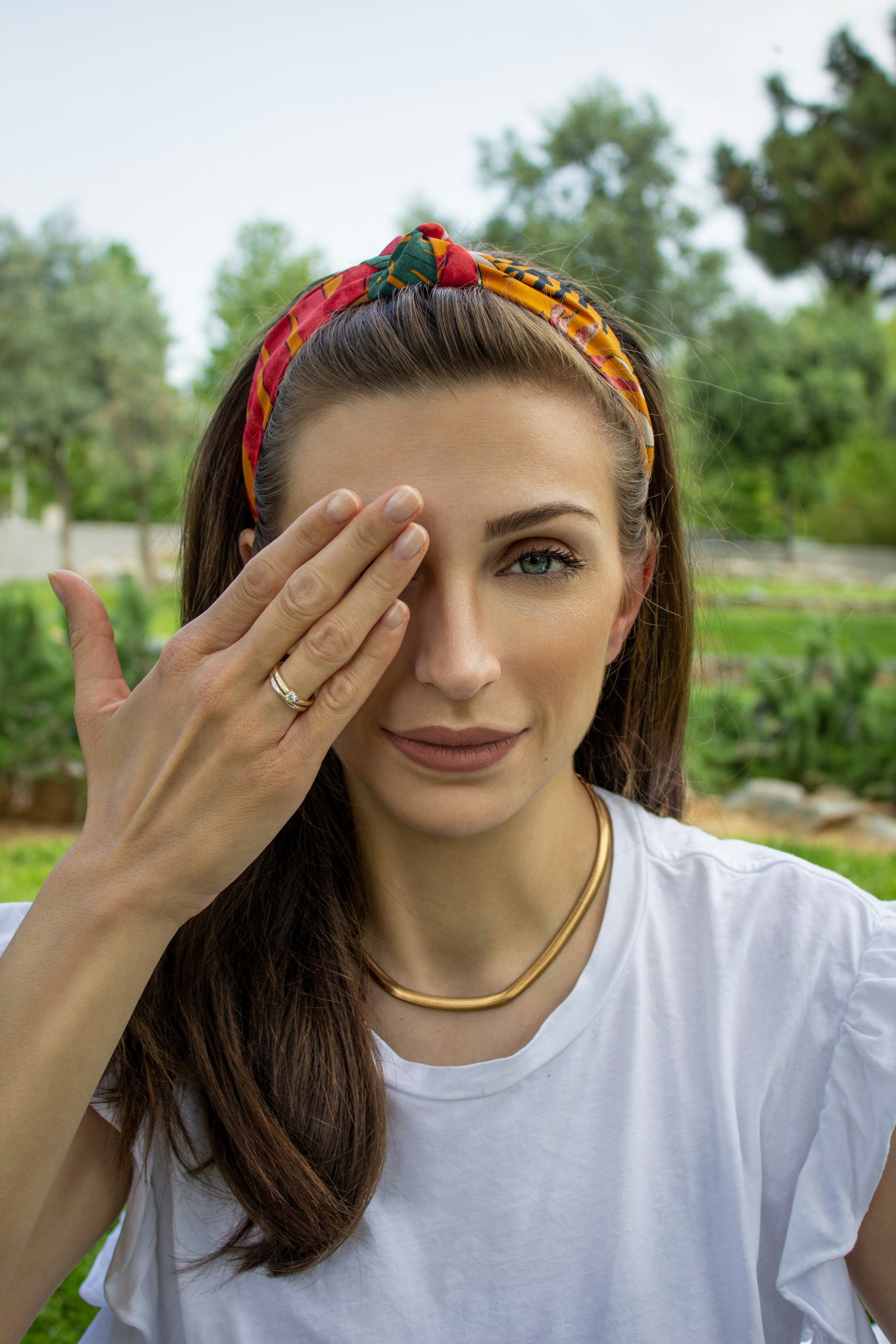 woman in white crew neck shirt with multicolored hair tie